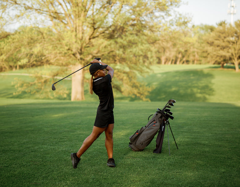 female golfer mid-swing 