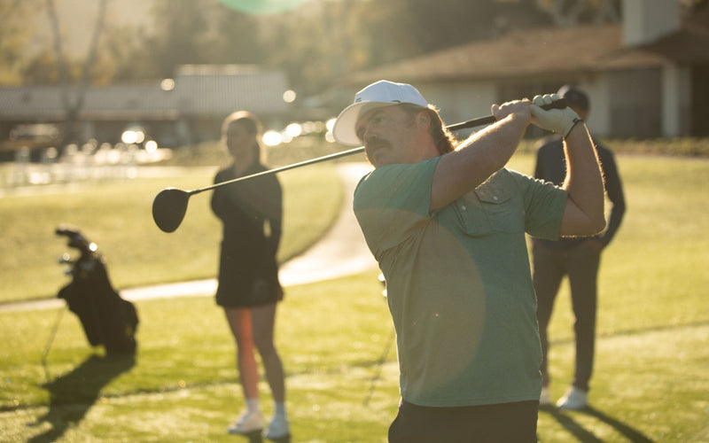 A golfer swinging a driver