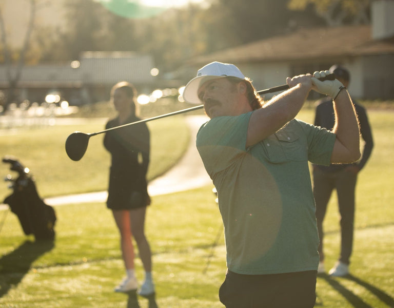 A golfer swinging a driver