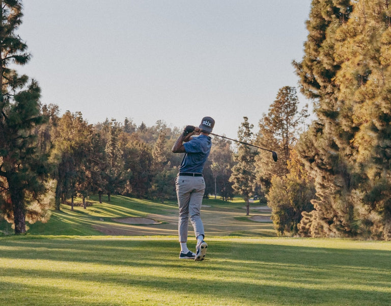 golfer hitting a distance drive of the tee