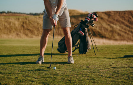 golfer sizing up club at tee