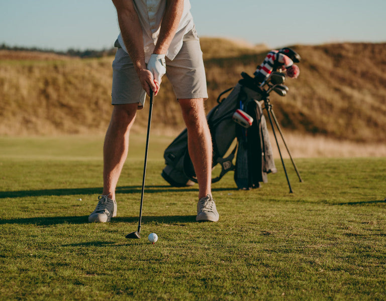 golfer sizing up club at tee