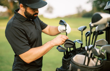 golfer choosing between irons and hybrids in bag