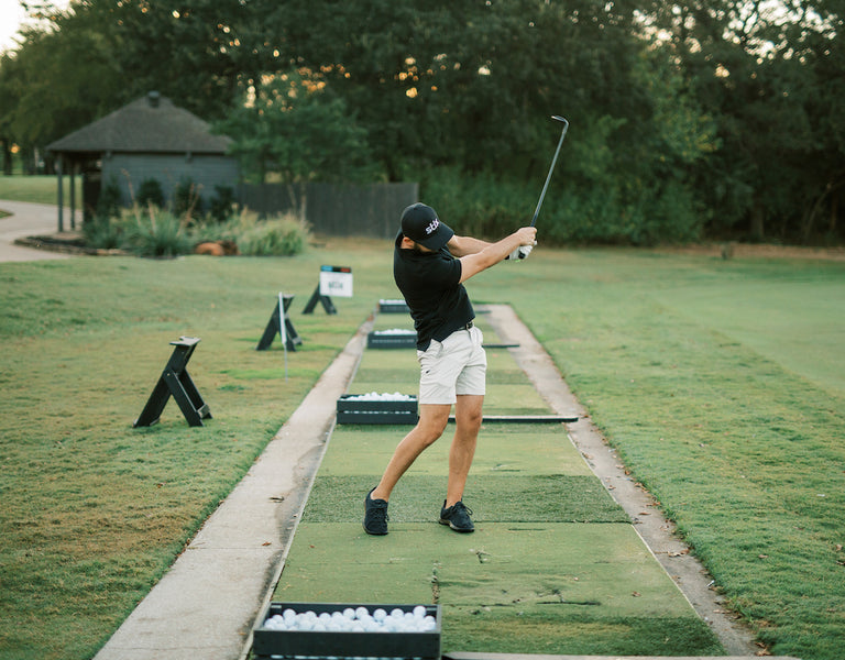 golfer practicing chip shot