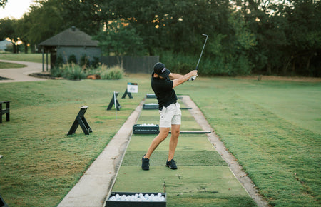 golfer practicing chip shot