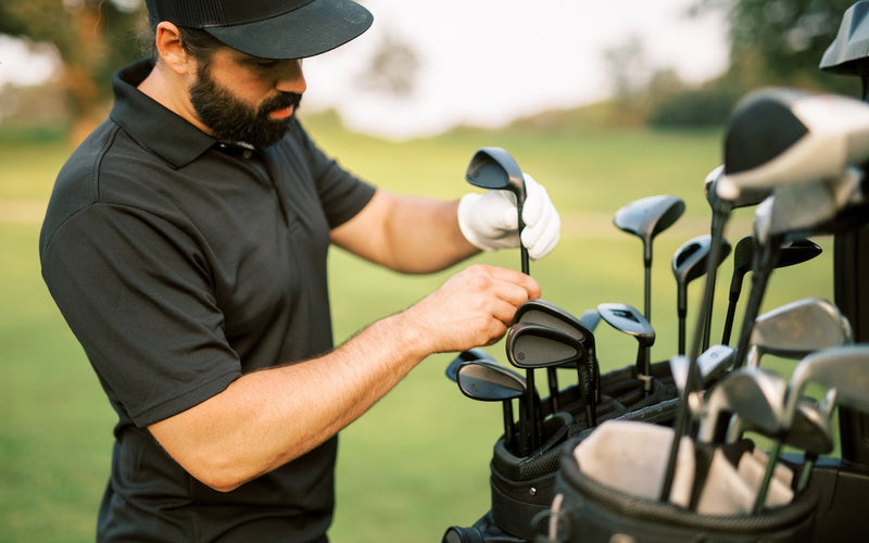 golfer selecting iron from bag
