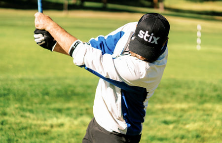 golfer hitting ball from tee and monitoring launch