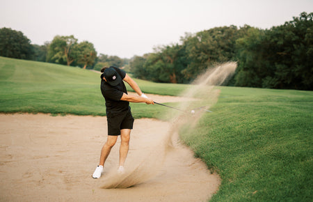 golfer using sand wedge