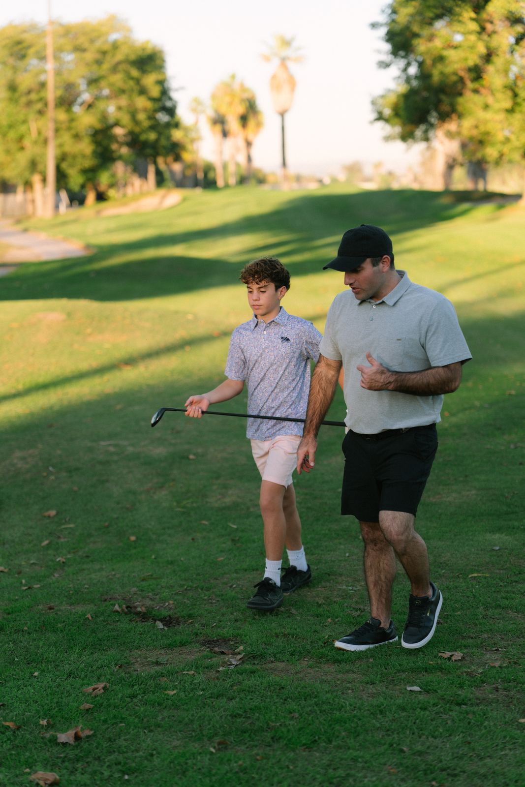 Dad and son walking the fairway